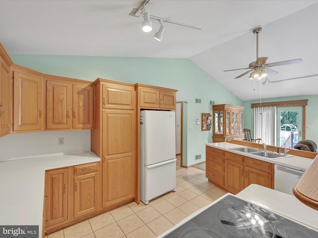 kitchen with lofted ceiling, sink, white appliances, light tile patterned floors, and ceiling fan