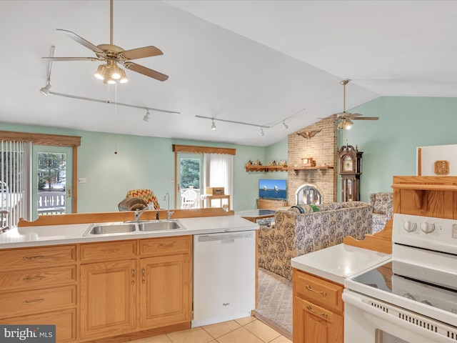 kitchen featuring vaulted ceiling, sink, light tile patterned floors, ceiling fan, and white appliances