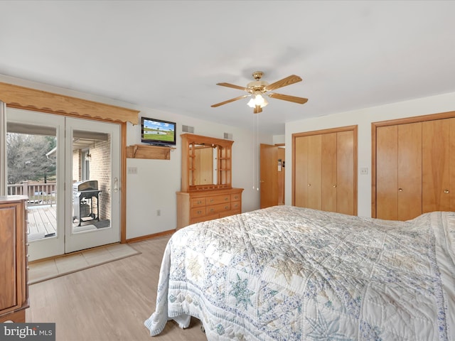 bedroom with two closets, access to outside, ceiling fan, and light hardwood / wood-style floors