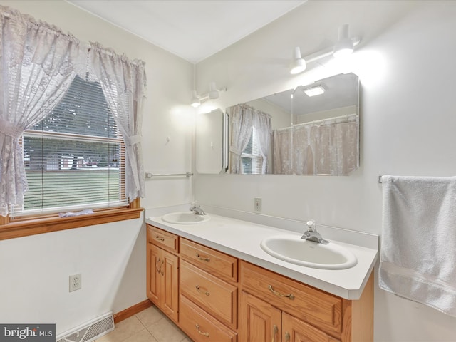 bathroom with tile patterned flooring and vanity