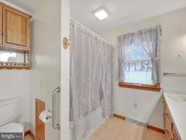 full bathroom featuring tile patterned flooring, shower / bath combo, vanity, and toilet