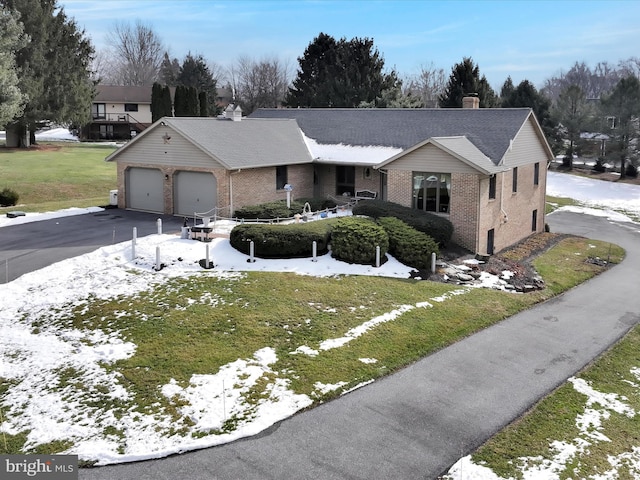 view of front of property with a garage and a front yard