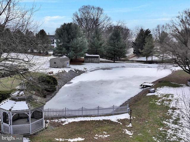 snowy yard with a gazebo