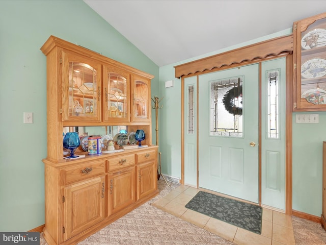 tiled entrance foyer with lofted ceiling