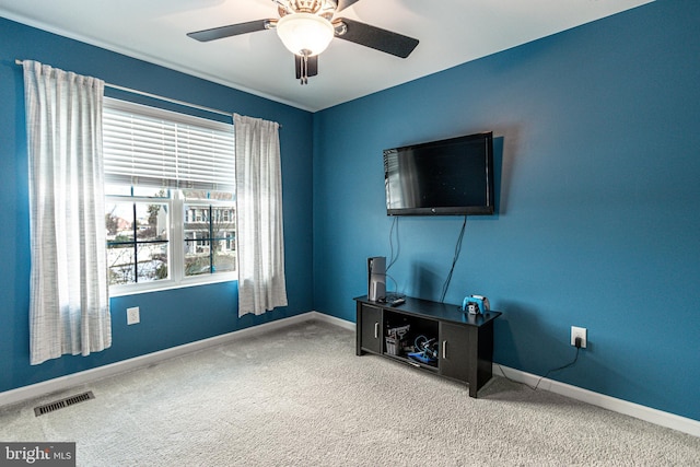 interior space with ceiling fan, carpet flooring, and a wealth of natural light