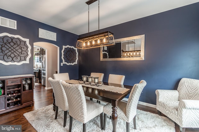 dining space with dark hardwood / wood-style floors