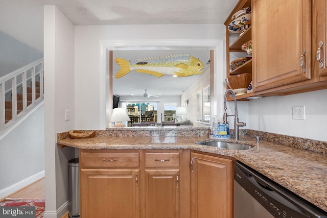 kitchen with sink, wood-type flooring, stainless steel dishwasher, ceiling fan, and light stone countertops