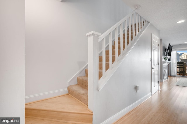 stairway featuring hardwood / wood-style flooring