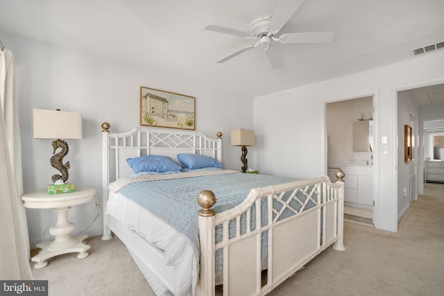 carpeted bedroom featuring ensuite bath and ceiling fan