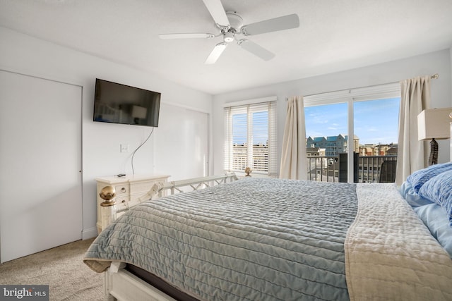 carpeted bedroom featuring access to outside and ceiling fan