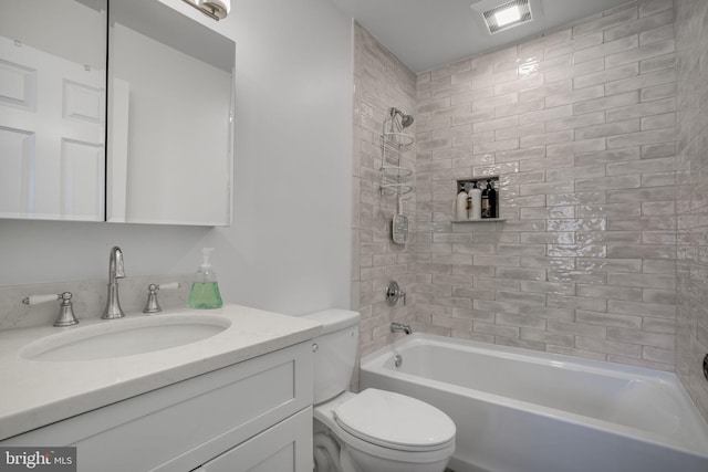 full bathroom with vanity, toilet, and tiled shower / bath combo