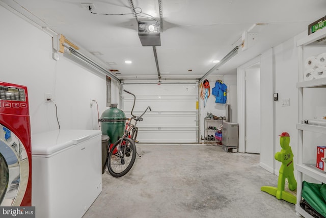 garage featuring a garage door opener, washing machine and clothes dryer, and refrigerator