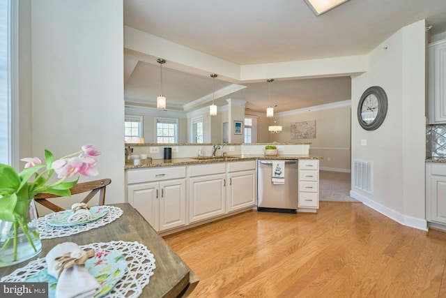 kitchen featuring light wood-type flooring, visible vents, a sink, backsplash, and stainless steel dishwasher