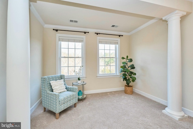 sitting room with visible vents, carpet flooring, and crown molding