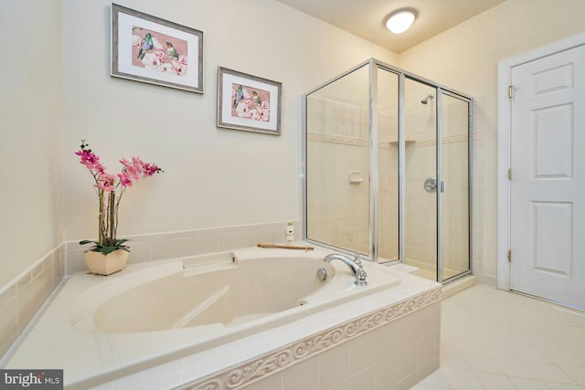 full bathroom featuring a bath and a shower stall