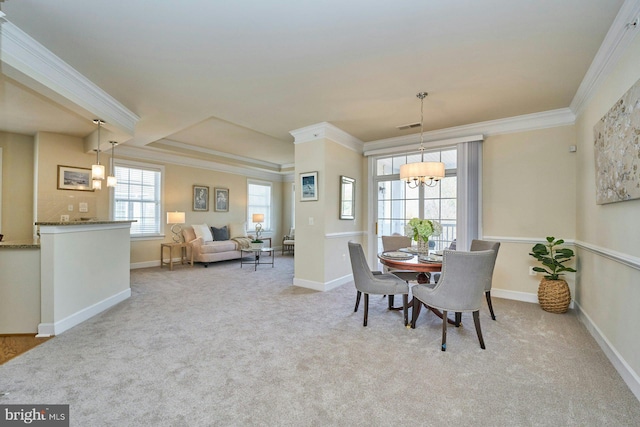 carpeted dining space with crown molding, baseboards, visible vents, and a chandelier