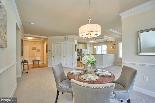 dining area with an inviting chandelier, crown molding, visible vents, and light carpet