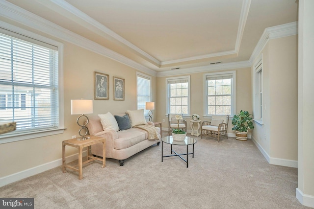 living room featuring light carpet, a healthy amount of sunlight, and ornamental molding