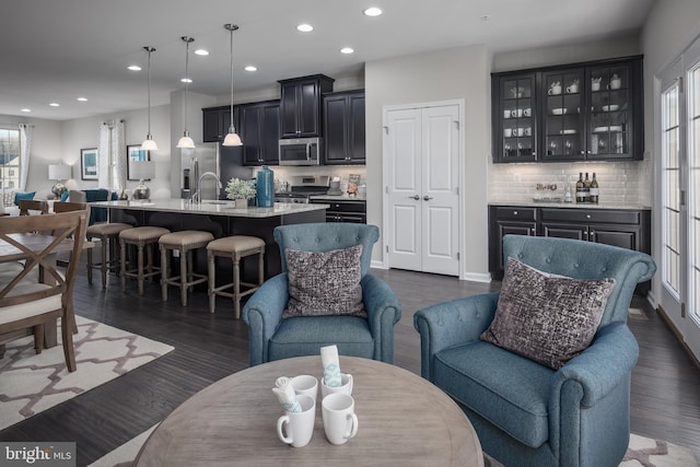 living room with dark hardwood / wood-style flooring and wet bar