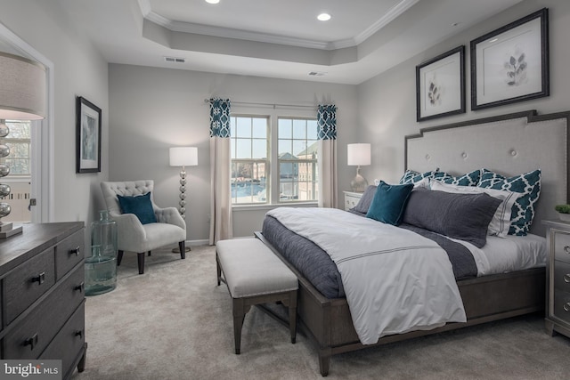 carpeted bedroom with a raised ceiling, ornamental molding, and multiple windows