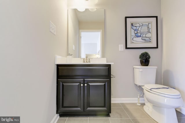 bathroom with tile patterned flooring, vanity, and toilet