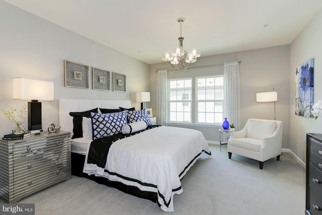 bedroom with a notable chandelier and light colored carpet