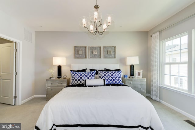 carpeted bedroom featuring a notable chandelier