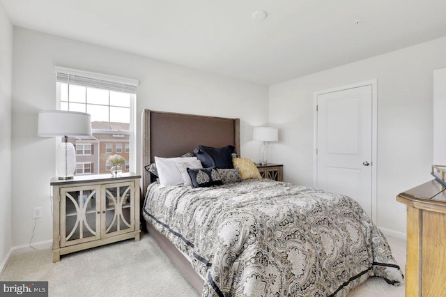 bedroom featuring light carpet