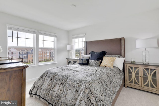 carpeted bedroom with multiple windows