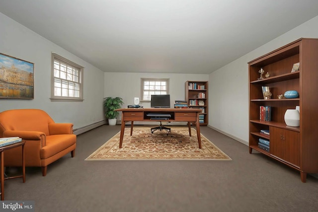 office area with a healthy amount of sunlight, baseboard heating, and built in shelves