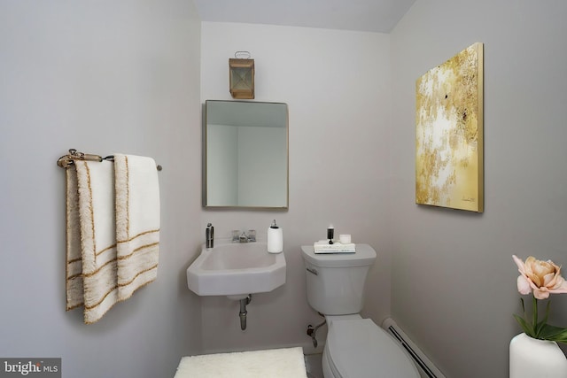 bathroom featuring sink, a baseboard radiator, and toilet