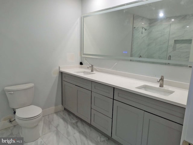 bathroom featuring vanity, toilet, and an enclosed shower