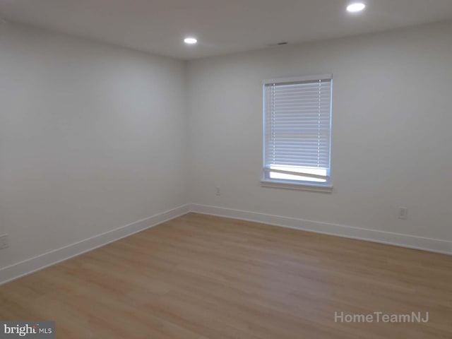 spare room featuring light hardwood / wood-style floors