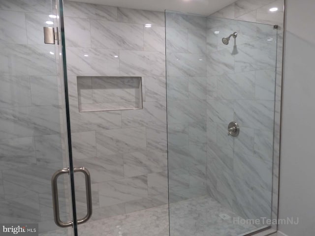 bathroom featuring a shower with door