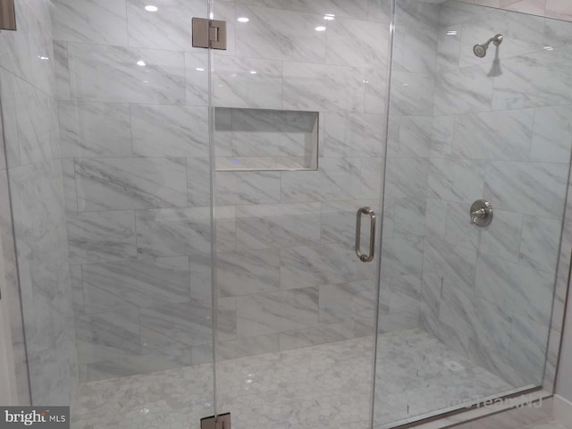 bathroom featuring a shower with door