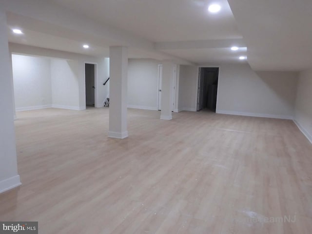 basement with light hardwood / wood-style flooring