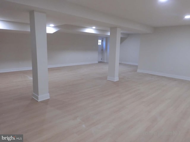 basement with light hardwood / wood-style floors