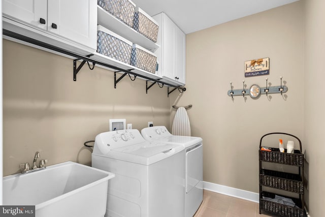 laundry room with separate washer and dryer, sink, light tile patterned floors, and cabinets