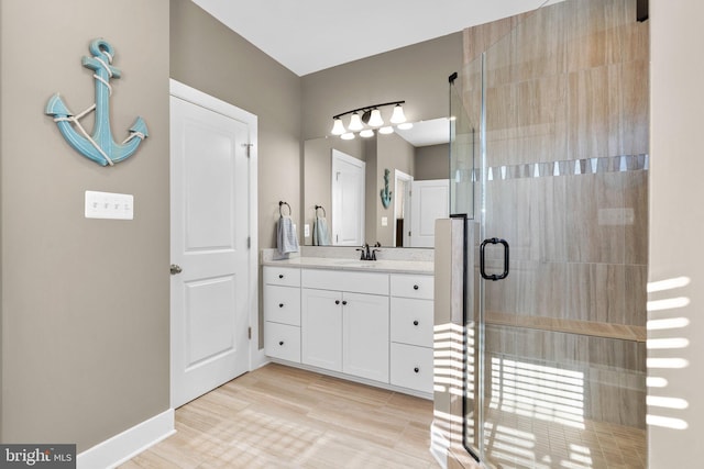 bathroom with vanity, wood-type flooring, and walk in shower