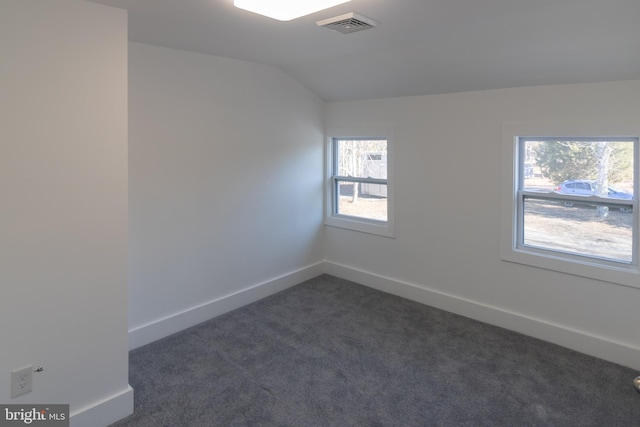 carpeted spare room with lofted ceiling