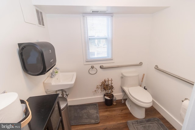 bathroom featuring hardwood / wood-style floors, sink, and toilet