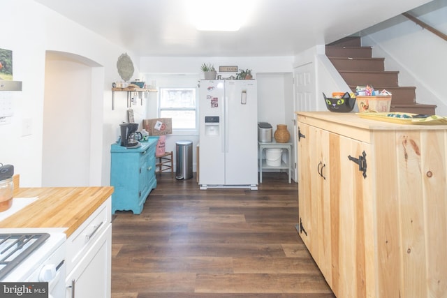 kitchen featuring butcher block counters, white appliances, dark wood-type flooring, and white cabinets