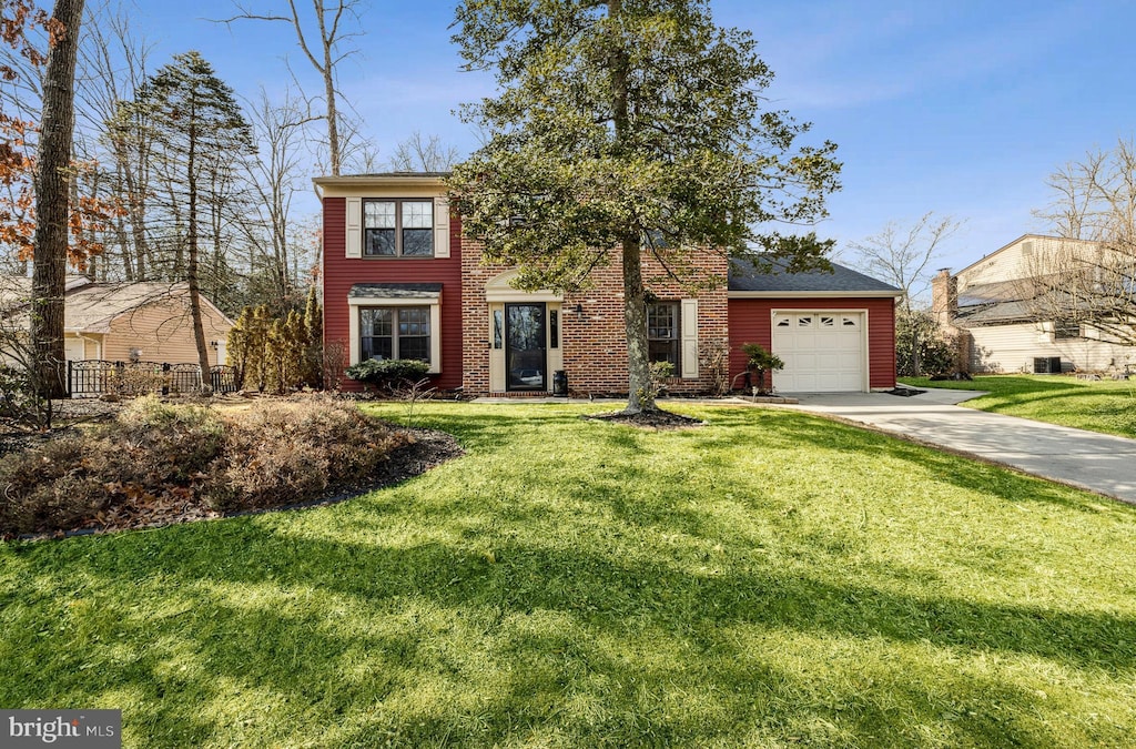 view of front facade with a garage and a front lawn