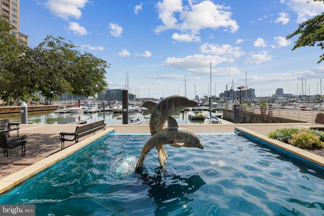 view of home's community with a water view and a dock