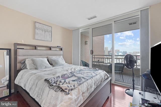 bedroom featuring dark wood-type flooring and access to outside