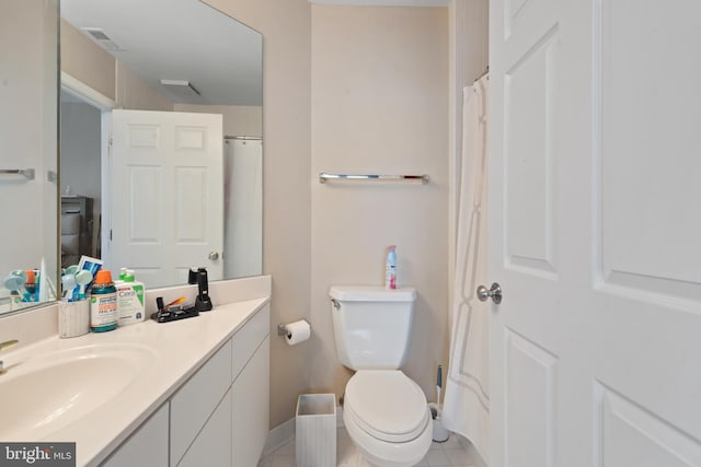 bathroom featuring vanity, curtained shower, tile patterned floors, and toilet