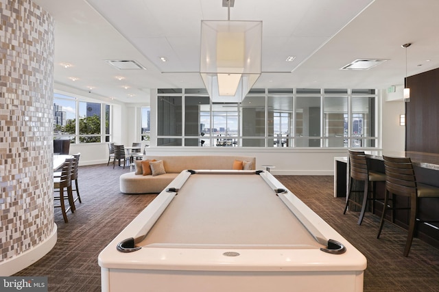 recreation room featuring dark carpet