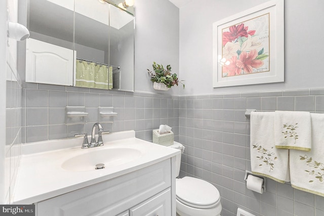 bathroom featuring vanity, tile walls, toilet, and walk in shower