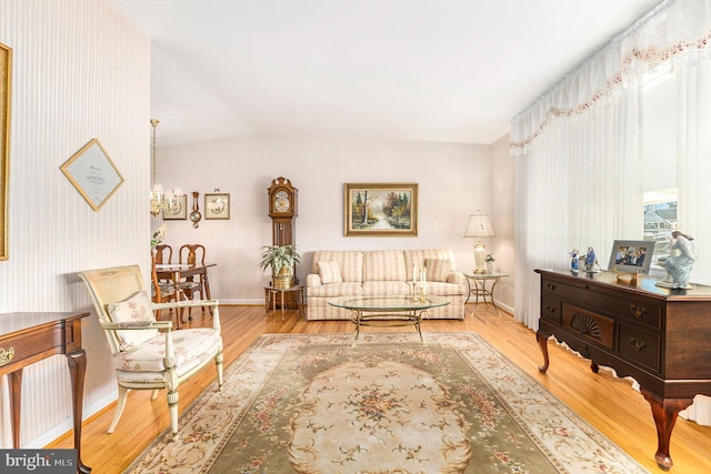 living room featuring a chandelier and light hardwood / wood-style flooring