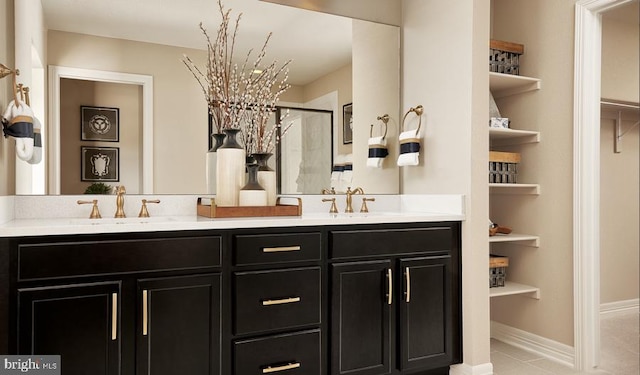 bathroom featuring built in shelves and vanity